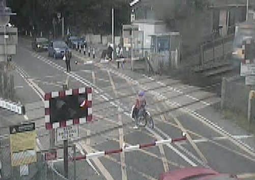 A cyclist came within inches of being hit by a train after dodging a level-crossing barrier at the Waterbeach crossing in Cambridgeshire.