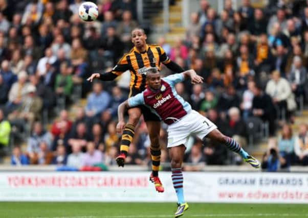 Hull City's Curtis Davies (behind) and Aston Villa's Leandro Bacuna battle for the ball in the air during the Barclays Premier League match at the KC Stadium.