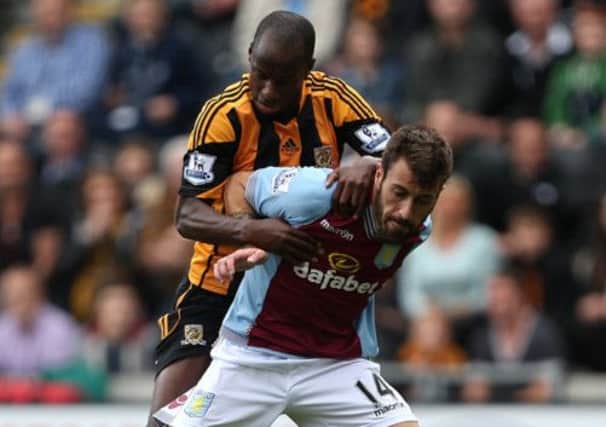 Aston Villa's Antonio Luna (right) and Hull City's Sone Aluko battle for the ball