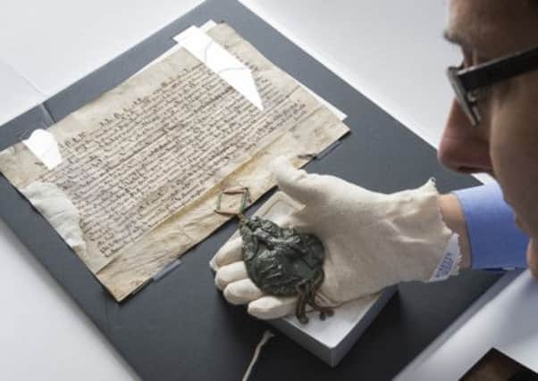 Coucillor Leigh Bramall with the Royal Charter and Seal granted by King Edward 1 in 1296