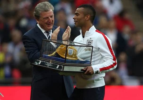 Ashley Cole is applauded by Roy Hodgson after receiving his 100th cap earlier this year.