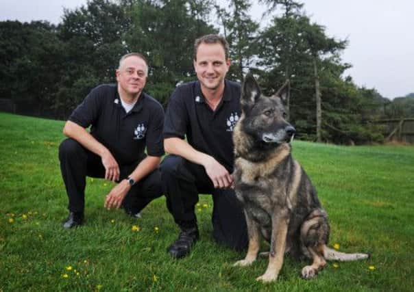 PC Duncan Matthews, Honorary Secretary and Trustee of Fireside K9 with his retired police dog Kiro joined by Rev Paul Wilcock, left, Force Chaplain and Chair of the Trustees of the charity which is focused on helping retired police dogs in West Yorkshire.