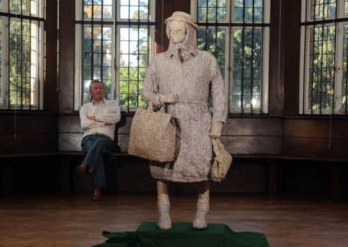 Artist Leonard J Brown with his statue. Picture by Gerard Binks