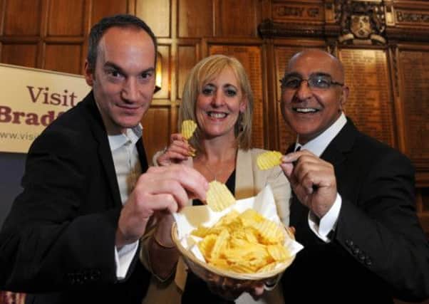 Visit Bradford's Tourism manager Patricia Tillotson lauches the curry crisp with Kevin Butterworth from Seabrook Crisps and Dill Butt from Akbars Restaurants