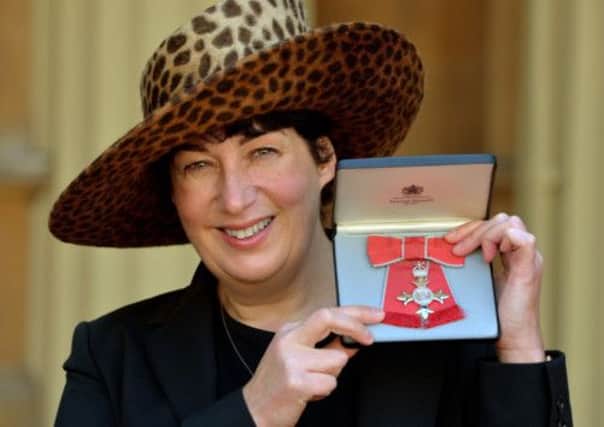 Joanne Harris holding her MBE for services to Literature