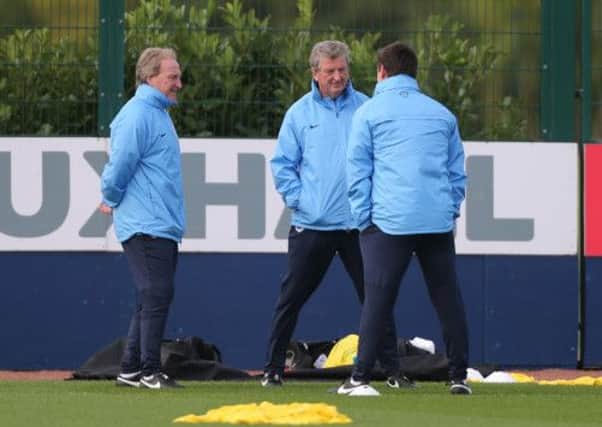 England Manager Roy Hodgson (centre) listens to Gary Neville and Ray Lewington (left) during a training session