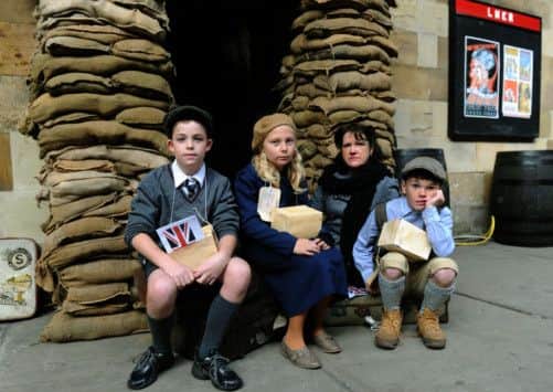 Pupils from Rillington CP school  - from left Max Lane, Marisha Christie and Seb Allan Swallow with Mrs Nicky McLoughlin,   outside the air raid shelter at  Pickering  station
