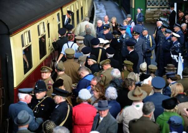 Servicemen and civilians waiting to board the train as it pulls into Pickering station