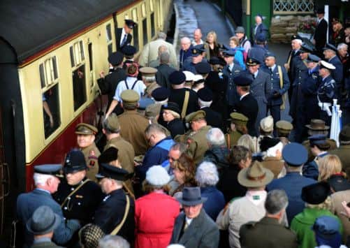 Servicemen and civilians  waiting to board the train as it pulls into  Pickering  station