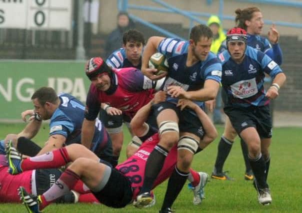 Daniel Sanderson tries to escape the tacklers from Bedford Blues.