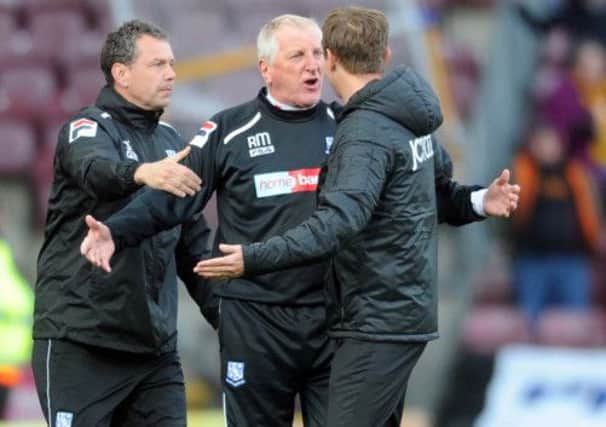 Phil Parkinson confronts Tranmere Manager Ronnie Moore at the final whistle