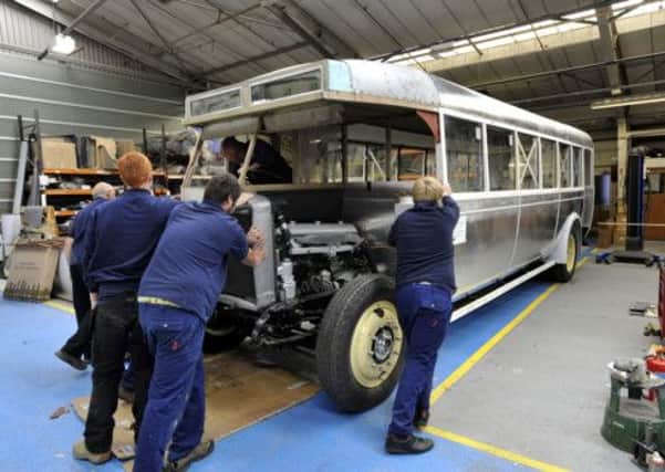The team of apprentices and craftsmen at Bluebird Vehicles restoring a 1929 Leyland bus