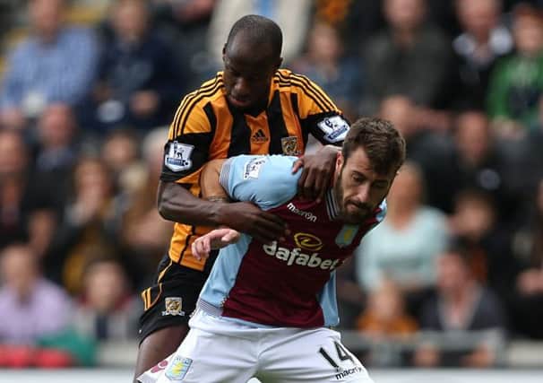 Aston Villa's Antonio Luna (right) and Hull City's Sone Aluko battle for the ball during the Barclays Premier League match at the KC Stadium, Hull.