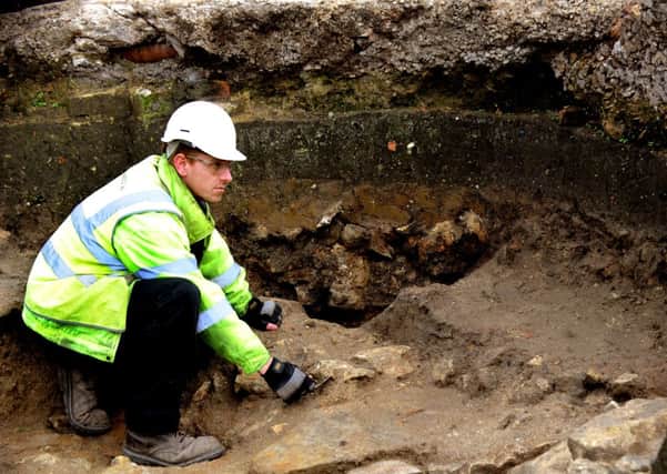 Archaeologist Toby Kendall  Field  working within one of the walls of   the remains of St John The Baptist Church in Hungate.