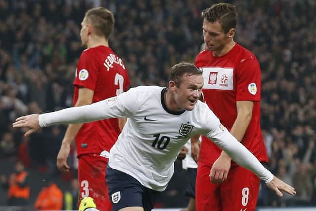England's Wayne Rooney celebrates after scoring the opening goal during the World Cup Group H qualification soccer match between England and Poland at Wembley stadium in London, Tuesday, Oct. 15, 2013.  (AP Photo/Matt Dunham)