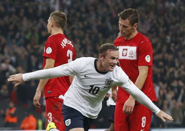 England's Wayne Rooney celebrates after scoring the opening goal during the World Cup Group H qualification soccer match between England and Poland at Wembley stadium in London, Tuesday, Oct. 15, 2013.  (AP Photo/Matt Dunham)