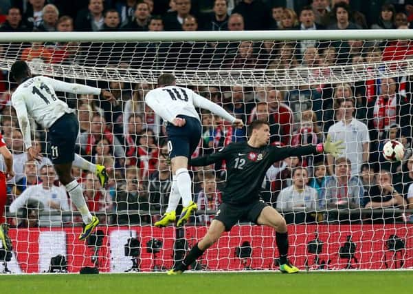 England's Wayne Rooney scores his side's first goal against Poland.