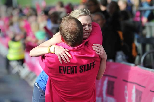 Rebecca Tomlinson gets a hug from her father Mike as she crosses the finishing line of the Yorkshire Marathon
