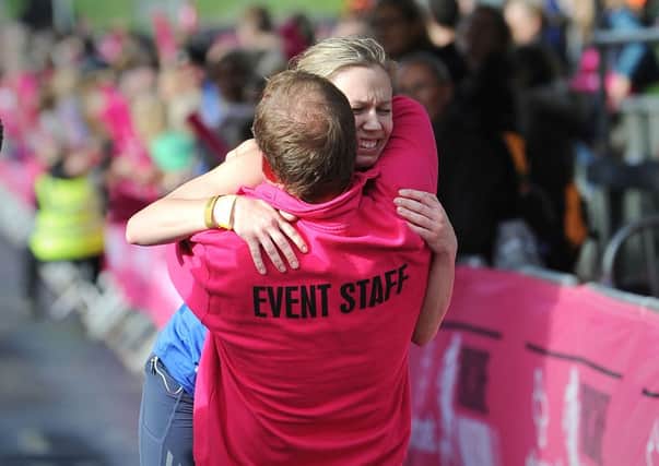 Rebecca Tomlinson gets a hug from her father Mike as she crosses the finishing line of the Yorkshire Marathon