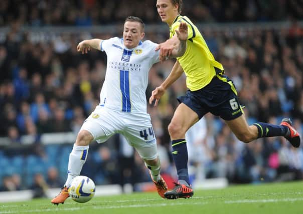 Leeds' Ross McCormack goes down after a challenge from Dan Burn.