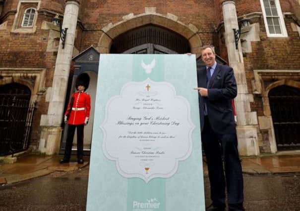 Peter Kerridge, CEO of Premier Christian Radio, delivers a huge Christening card signed by 5,000 listeners to St James's Palace in London