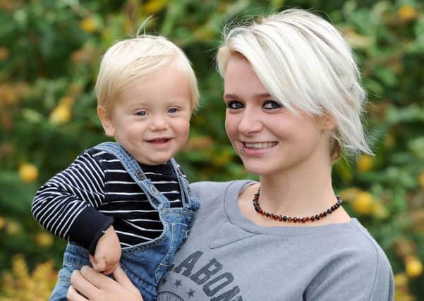 Sarah Wise with her one year old son Billy at home in Leeds. Picture by Gerard Binks