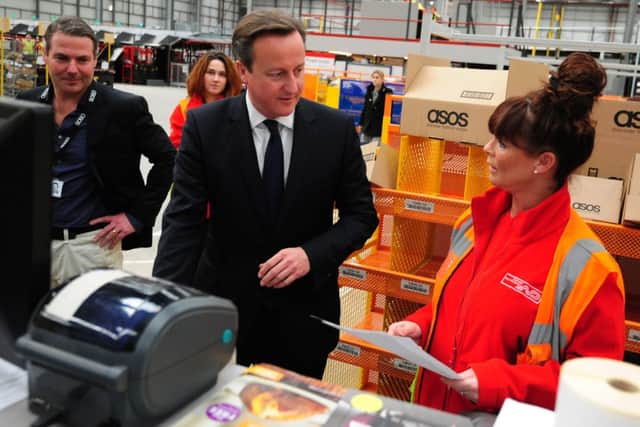 David Cameron with Dispach Team Leader Adele Simpson during a visit to ASOS, Barnsley.