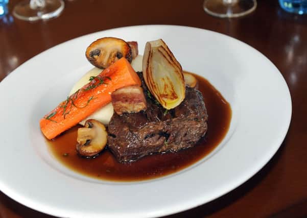 A large plate of ale braised beef cheek, horseradish mash and root vegetables