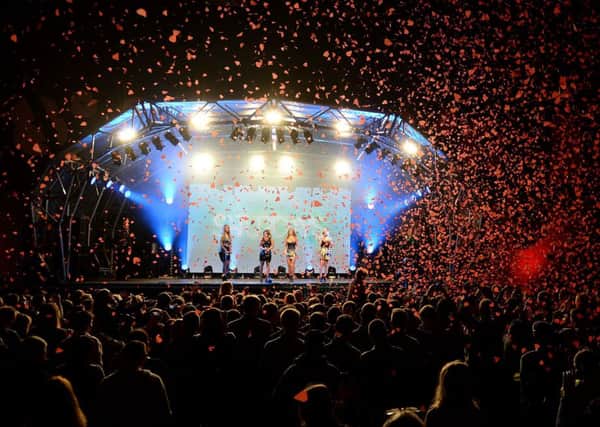 The Saturdays perform as poppies fall at a concert at RAF Northolt to launch the Royal British Legion's Poppy Appeal 2013.