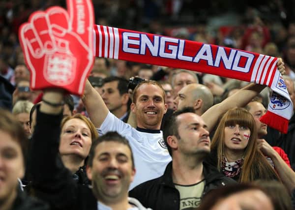 England fans cheer on their side in the stands during the FIFA 2014 World Cup Qualifying, Group H match at Wembley Stadium