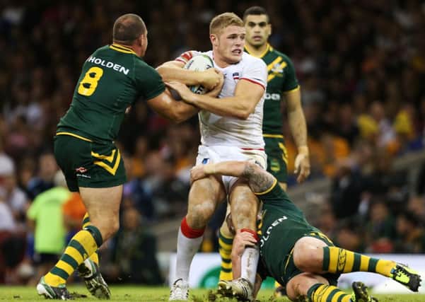 England's George Burgess is tackled by Australia's Matthew Scott and Cooper Cronk during the 2013 World Cup match at the Millennium Stadium, Cardiff. Picture: Lynne Cameron/PA Wire