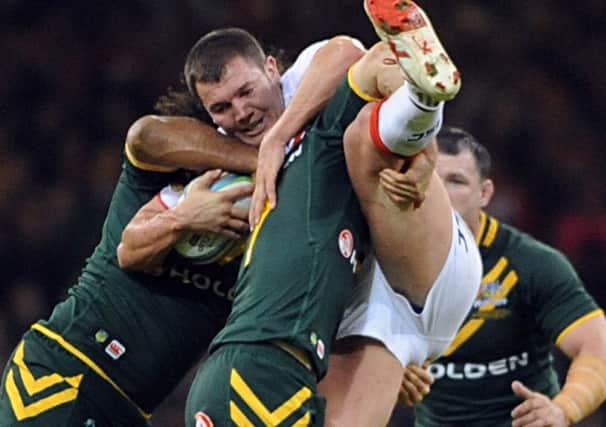 Brett Ferres is lifted in the tackle