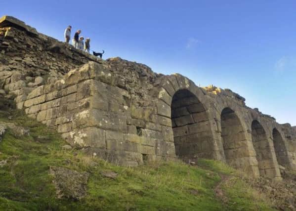 Visitors to a blustery North York Moors enjoy the spectacular views from the Ironstone kilns left over from the mining industry
 which once dominated Rosedale. Picture: Tony Bartholomew