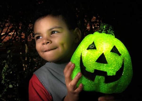 Alan's grandson Logan Tosney, two, with a Halloween lantern.
