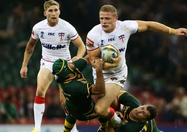 England's George Burgess is tackled by Australia's Cooper Cronk and Greg Bird