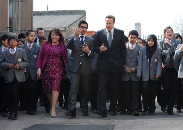 David Cameron meets headteacher Sajid Hussain and children from Kings Science Academy, Bradford on a visit last year