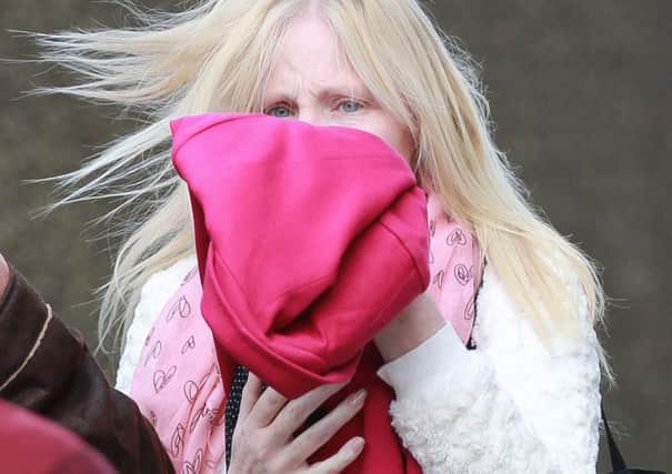 Cathy Watson tried to shield her face outside court. Picture: Ross Parry Agency