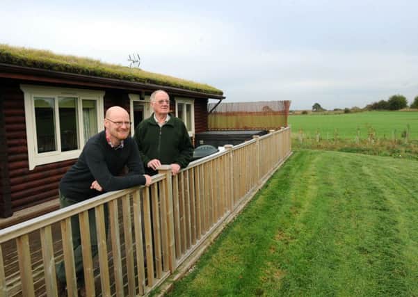 James and Paul Middlebrook  of Keepers Cottage, Brayton  outside one of their log cabin holiday lets.