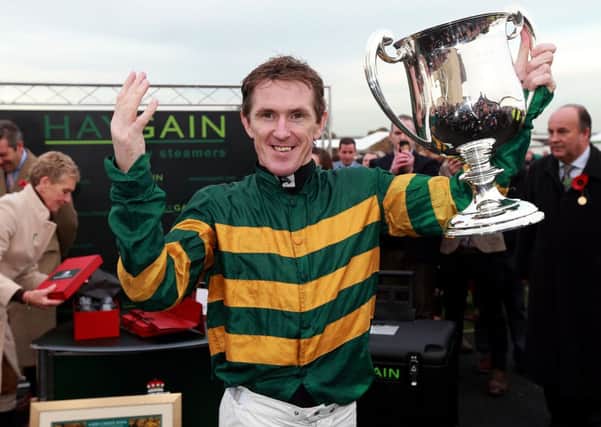 Tony McCoy celebrating his 4,000th winner after victory in the Weatherbys Novices´ Hurdle at Towcester Racecourse.