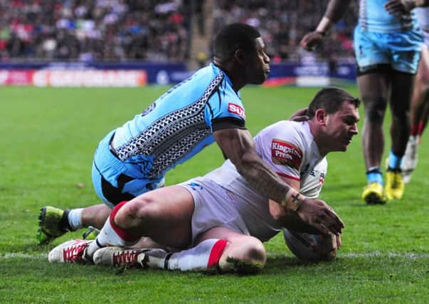 England's Brett Ferres goes over to score a try under pressure from Fiji's Kevin Naiqama. picture: Anna Gowthorpe/PA Wire