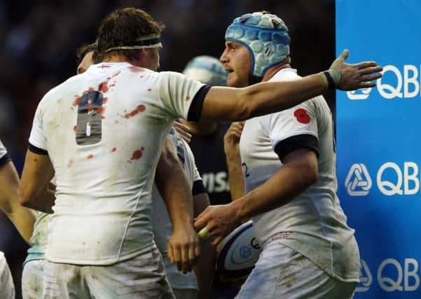 England's Ben Morgan (right) celebrates scoring England's fourth try with team mate Tom Wood (left) during the QBE International at Twickenham, London.