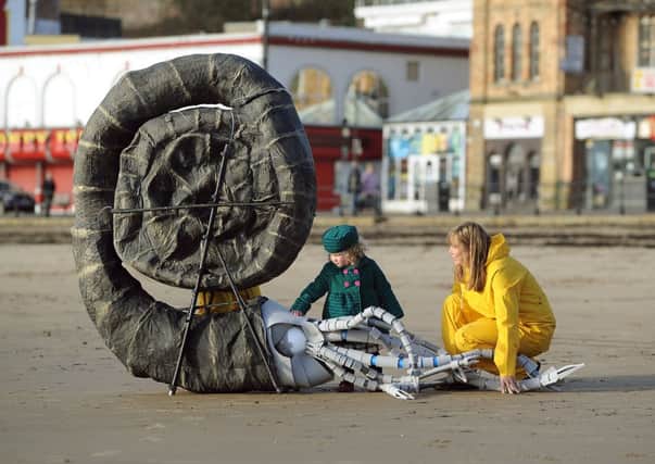 Giant ammonite on the South Bay Beach, Scarborough, with  Zoe Naylor and Martha Riley, aged 2