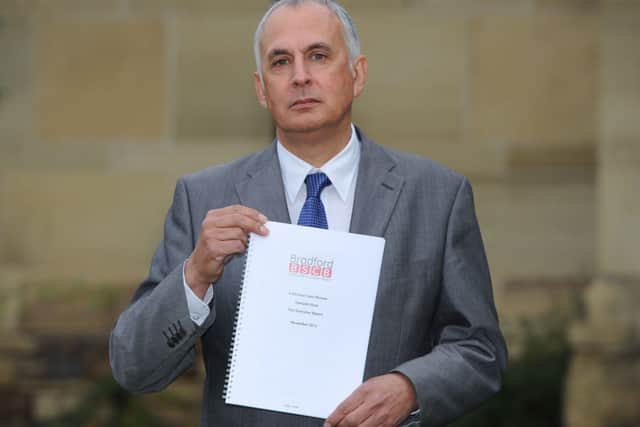 Professor Nick Frost, Independent Chair of the Bradford Safeguarding Children Board, holds a copy of the serious case review into the death of Hamzah Khan