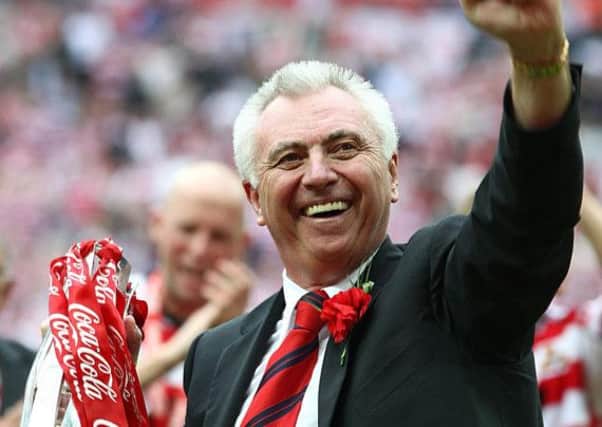 Doncaster Rovers chairman John Ryan celebrates with the trophy during the Coca-Cola League One Play Off Final at Wembley in 2008.