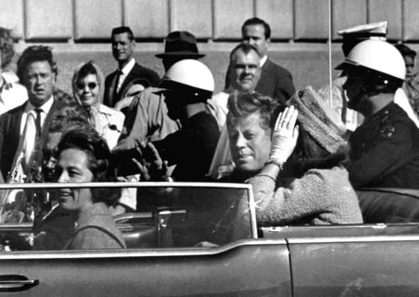 President John F. Kennedy is seen riding in motorcade approximately one minute before he was shot on Nov. 22, 1963.