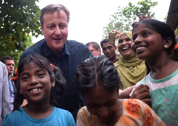 David Cameron meets Tamil refugees in the welfare village of Sabapathopillaia, in northern Sri Lanka, who were made homeless during the 26 year long civil war.