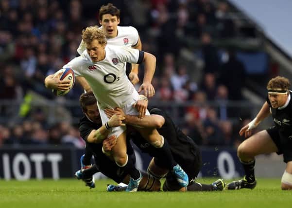 England's Billy Twelvetrees is tackled by New Zealand's Richie McCaw