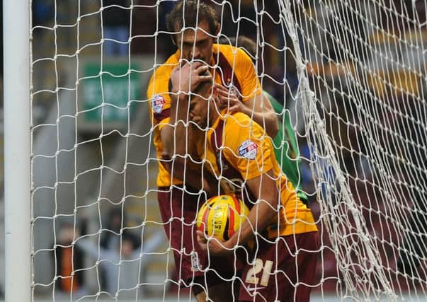 Nahki Wells and James Hanson celebrate his first goal.