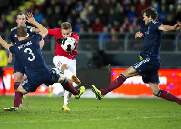 Scotland's Steven Whittaker, left and Gordon Greer right, attempt to block a shot from Marcus Pedersen of Norway.