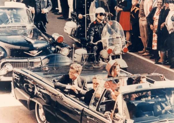 President Kennedy's motorcade drives through Dallas